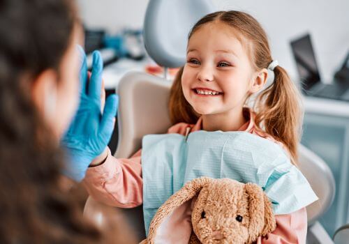 Child at dentist working with dental hygienists.